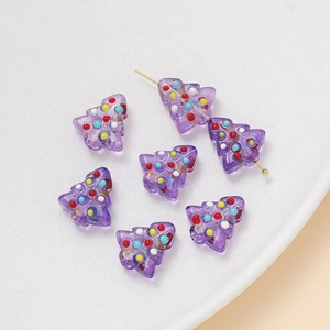 Detailed view of purple translucent Christmas tree beads with colorful hand-painted dots
