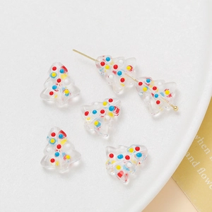 Macro view of Christmas tree acrylic beads with colorful polka dots for DIY jewelry