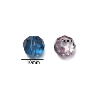 Detail view of 10mm faceted gradient glass beads showing 1.4mm hole size for DIY jewelry