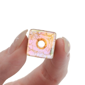 Macro shot of an iridescent ice-crackled square acrylic bead for DIY jewelry making