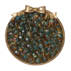 Macro shot of 10mm faceted gradient crystal beads in a gold tray for DIY jewelry