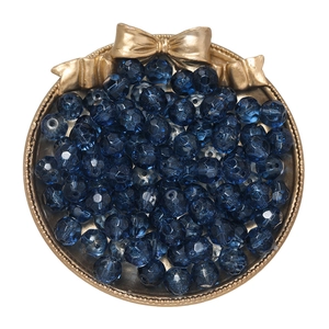 Close-up of 10mm faceted gradient blue mermaid glass beads in a golden decorative tray