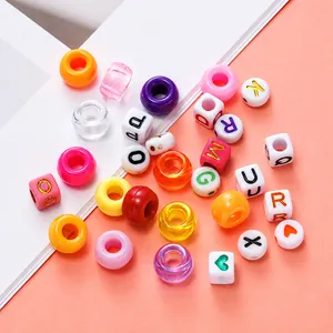 Macro shot of colorful large-hole candy beads and letter charms for DIY jewelry making
