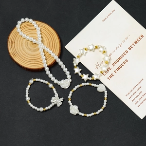 Detail view of pearl jewelry set with rose pendant and star charms for kids DIY