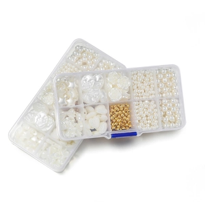 Detailed view of 10-grid storage boxes with various white faux pearls and gold DIY beads