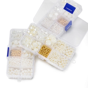 Detail of 10-grid DIY jewelry kit with assorted pearl shapes and gold spacer beads