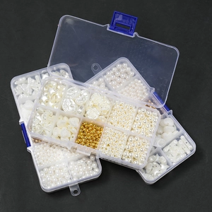 Detailed view of DIY bead kit with diverse faux pearls and shapes in a clear storage box