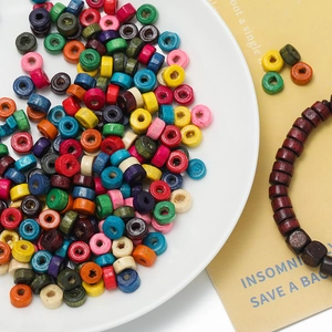 Macro shot of colorful wooden macaron cylinder beads for DIY jewelry making