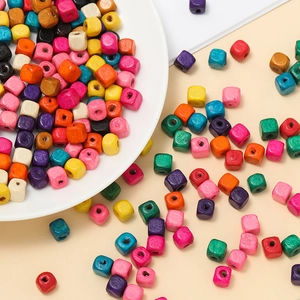 Close-up of colorful square wooden beads for DIY crafts including red, blue and yellow