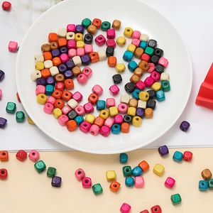 Macro shot of colorful 10mm square wooden beads with holes for DIY jewelry making