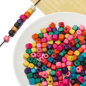 Macro view of colorful 10mm square wooden beads for DIY jewelry and crafts making