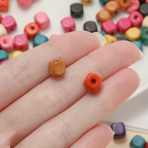Close-up of colorful cube wood beads for DIY jewelry with center hole for stringing