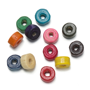 Close-up of assorted macaron-colored cylindrical wooden beads for DIY jewelry making