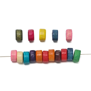 Macro detail of colorful cylindrical wooden beads with natural grain for DIY jewelry making