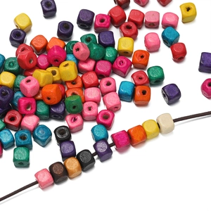 Macro shot of colorful cube wooden beads with center holes for DIY jewelry making