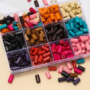 Close-up of colorful wooden tube beads in a 12-slot clear storage box for DIY jewelry