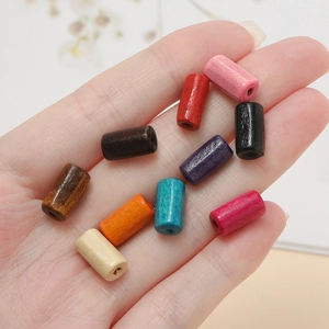 Macro shot of colorful cylindrical wooden beads with natural texture for DIY jewelry making