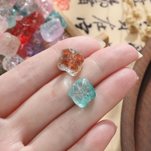 Close-up of 11.5mm amber and blue glass lion beads for DIY jewelry making