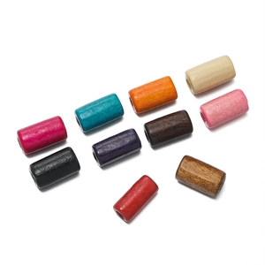 Close-up of assorted colorful cylindrical wooden beads with natural grain for DIY jewelry