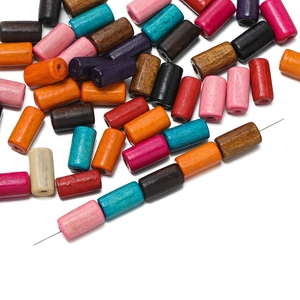 Close-up of assorted colorful cylindrical wooden beads for DIY jewelry and bracelets