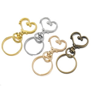 Set di fermagli a moschettone a cuore in oro, argento, oro rosa e bronzo antico