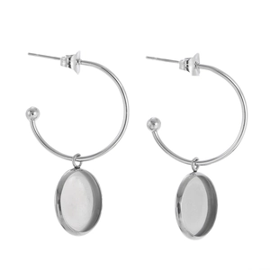 Detail of silver C-shaped hoop earrings with blank round disc charms for DIY jewelry making