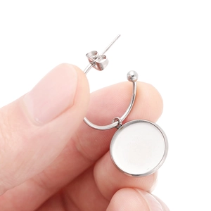 Close-up of silver stainless steel DIY earring hooks with round bezel tray setting