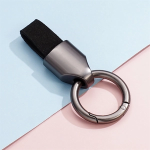 Detailed view of matte metal spring ring and premium black suede leather car keychain