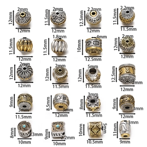 Detailed view of twenty Tibetan silver alloy beads with auspicious cloud patterns