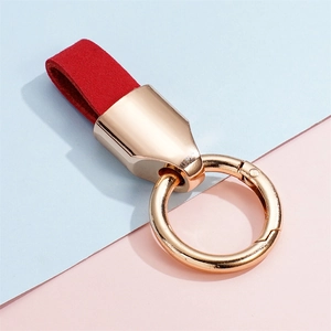 Close-up of red suede leather key ring loop with rose gold polished metal spring clasp