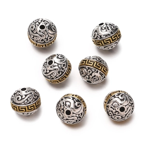 Detailed view of silver Tibetan alloy beads with gold Greek fret and cloud carvings