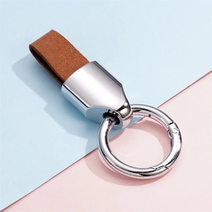 Close-up of brown leather keychain with polished silver metal spring ring and link