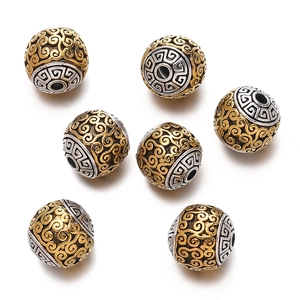 Detailed view of silver and gold Tibetan-style beads with cloud pattern for DIY jewelry