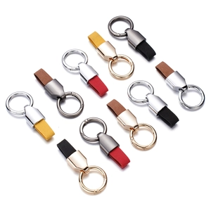 Detailed view of assorted leather keychains with metallic ring clips in various colors