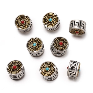 Macro shot of Tibetan style alloy beads with silver and gold finish and cloud patterns