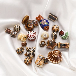 Macro shot of assorted animal ceramic beads including owl and elephant for DIY jewelry