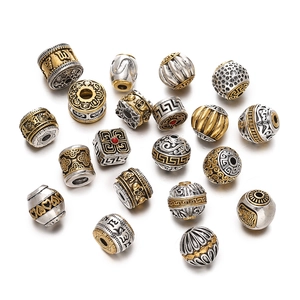 Macro detail of vintage Tibetan silver beads with engraved cloud patterns and bicolor finish