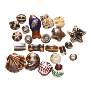 Macro shot of assorted glazed ceramic animal beads including owls and shells for DIY jewelry