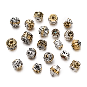 Detailed view of vintage Tibetan silver and gold alloy spacer beads for jewelry making