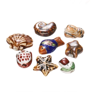 Macro detail of assorted glazed ceramic animal beads with intricate floral patterns