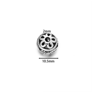 Detailed close-up of 10.5mm hollow floral enamel copper bead with 2mm hole for DIY jewelry