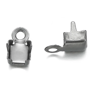 Macro view of silver square claw settings with loops for jewelry making and DIY crafts