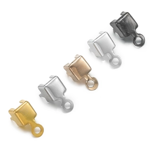 Macro detail of five metal jewelry cord end crimps in multiple metallic finishes
