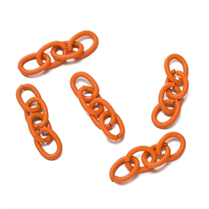 Detail shot of bright orange coated metal 4-link chains for DIY jewelry making