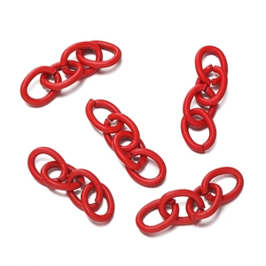 Macro detail of red matte painted four-link metal chains for DIY jewelry making