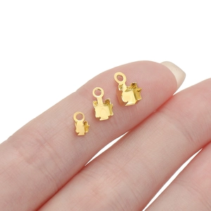 Three sizes of gold metal prong settings for DIY jewelry making shown on fingertips
