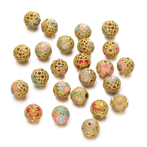 Detailed close-up of hollow gold-plated cloisonné enamel flower beads for jewelry making