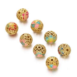 Macro shot of gold-plated hollow cloisonné beads with colorful enamel flower patterns