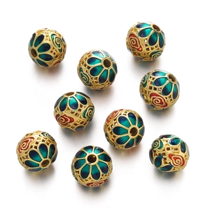 Macro detail of gold cloisonne hollow beads with green enamel petals for DIY jewelry