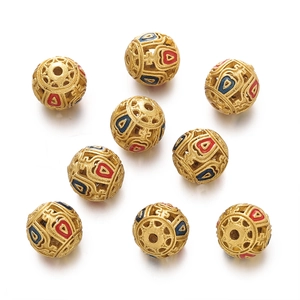 Detailed macro view of hollow gold-plated beads with red and blue enamel flower motifs
